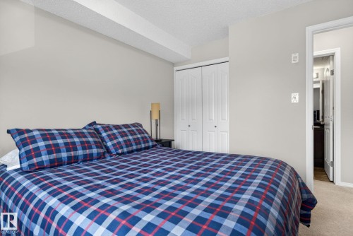 This room features light-colored walls and carpeted flooring, creating a neutral canvas - 215 1080 Mcconachie Boulevard, Edmonton, AB - Indoor Photo Showing Bedroom