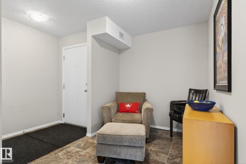 Entryway featuring a white door, tiled flooring, and neutral wall paint - 215 1080 Mcconachie Boulevard, Edmonton, AB - Indoor Photo Showing Other Room