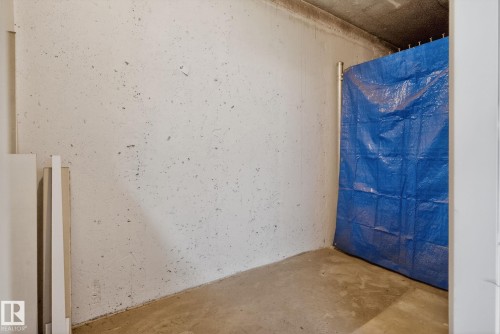 The property features a concrete floor and a textured wall - 215 1080 Mcconachie Boulevard, Edmonton, AB - Indoor Photo Showing Other Room