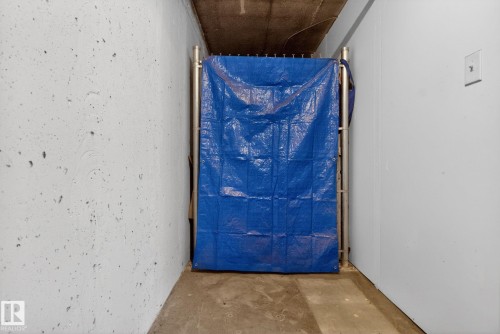 This space features concrete flooring and a concrete ceiling, with light-colored walls - 215 1080 Mcconachie Boulevard, Edmonton, AB - Indoor Photo Showing Other Room