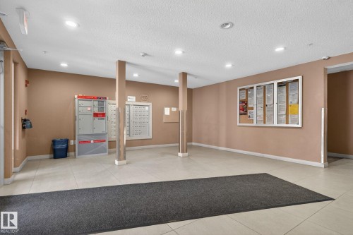Inviting entrance area with tile flooring, recessed lighting, and a neutral color palette - 215 1080 Mcconachie Boulevard, Edmonton, AB - Indoor