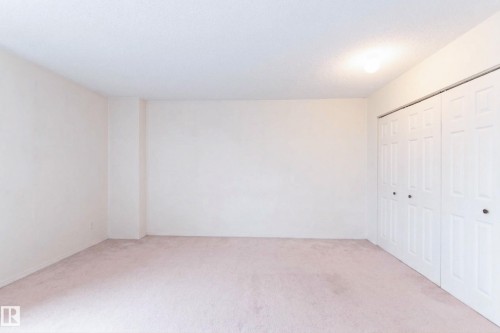 This room features light-colored walls and soft carpeting - 1004 11027 87 Avenue, Edmonton, AB - Indoor Photo Showing Other Room