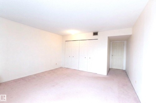 Bedroom featuring light-colored carpeting, white walls, and a white ceiling - 1004 11027 87 Avenue, Edmonton, AB - Indoor Photo Showing Other Room