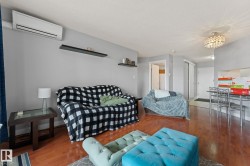The living area features hardwood flooring, light gray walls, and a white ceiling - 