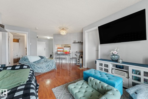 The property features hardwood flooring throughout the main living areas, light gray walls, and white trim - 208 6710 158 Avenue, Edmonton, AB - Indoor Photo Showing Living Room
