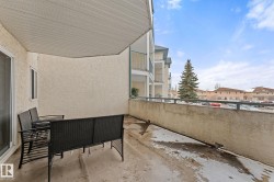 The property features a private balcony with a concrete floor and a solid wall on one side - 