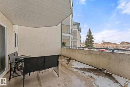 The property features a private balcony with a concrete floor and a solid wall on one side - 208 6710 158 Avenue, Edmonton, AB - Outdoor With Balcony With Exterior