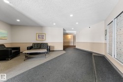 The common area features recessed lighting, a two-tone wall finish, and a combination of carpeted and tiled flooring - 