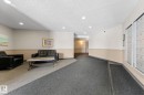 The common area features recessed lighting, a two-tone wall finish, and a combination of carpeted and tiled flooring - 208 6710 158 Avenue, Edmonton, AB  - Indoor 