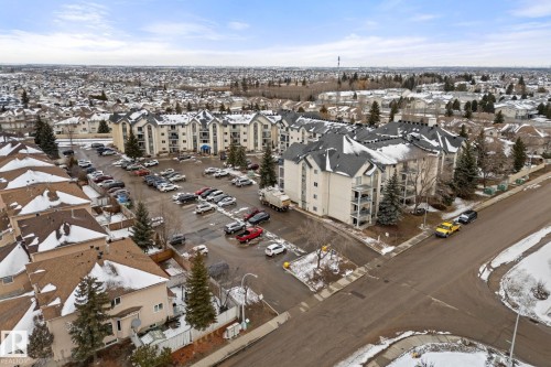 The property features a large parking area with paved surfaces - 208 6710 158 Avenue, Edmonton, AB - Outdoor With View