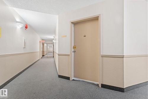 Entryway featuring a solid door, neutral wall tones, and carpeted flooring - 208 6710 158 Avenue, Edmonton, AB - Indoor Photo Showing Other Room