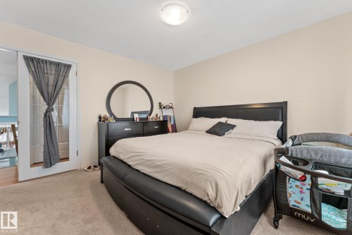 Bedroom with neutral-toned walls and carpeted flooring - 7252 152C Avenue, Edmonton, AB - Indoor Photo Showing Bedroom
