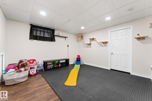 This versatile room features light-colored walls, recessed lighting, and a white paneled ceiling - 7252 152C Avenue, Edmonton, AB - Indoor