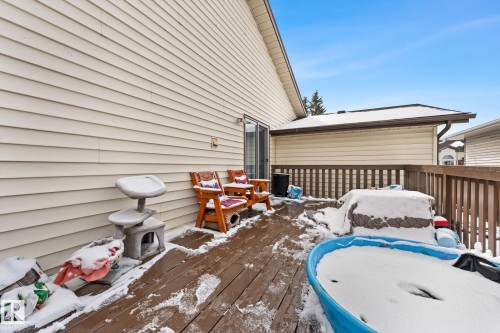 The property features a wooden deck with a railing, providing outdoor space - 7252 152C Avenue, Edmonton, AB - Outdoor With Deck Patio Veranda With Exterior