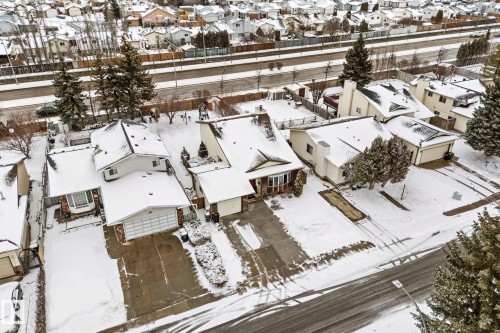 An aerial view of the property, featuring a residential street and a driveway leading to a garage - 7252 152C Avenue, Edmonton, AB - Outdoor With View