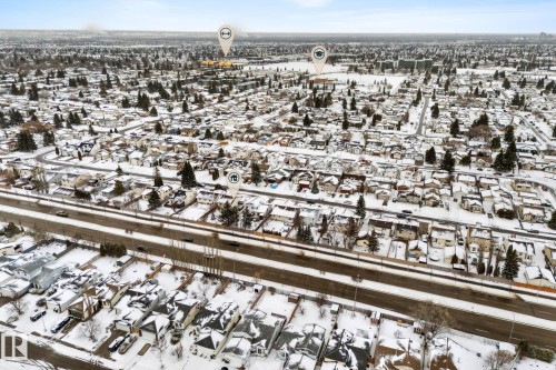 Aerial view of the neighborhood showcasing numerous properties with snow-covered roofs and yards, along with a prominent road - 7252 152C Avenue, Edmonton, AB - Outdoor With View
