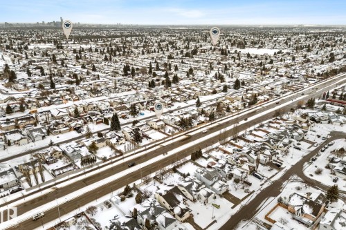 Aerial view showcasing a residential area with snow-covered rooftops and trees - 7252 152C Avenue, Edmonton, AB - Outdoor With View