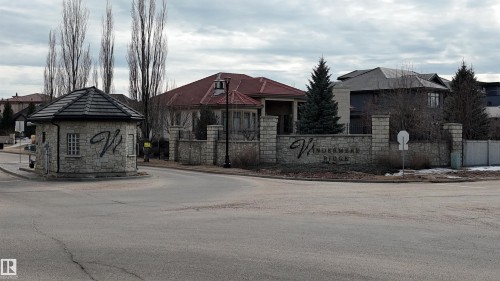 Welcome to Windermere Ridge, featuring a stone entrance with a guardhouse and a prominent community sign - 24 Windermere Drive, Edmonton, AB 