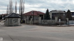 Welcome to Windermere Ridge, featuring a stone entrance with a guardhouse and a prominent community sign - 