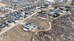 This property features a contemporary-style residence with a flat roof and a paved driveway - 