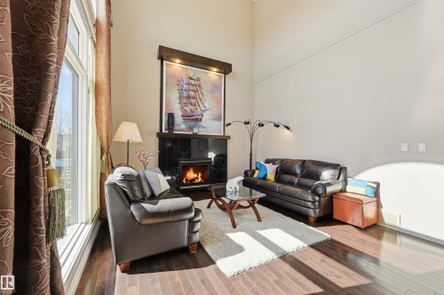 831 Hollands Landing, Edmonton, AB - Indoor Photo Showing Other Room With Fireplace