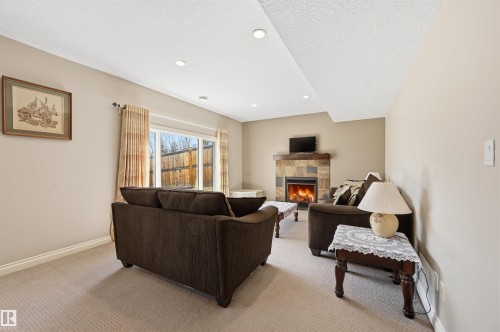831 Hollands Landing, Edmonton, AB - Indoor Photo Showing Other Room With Fireplace