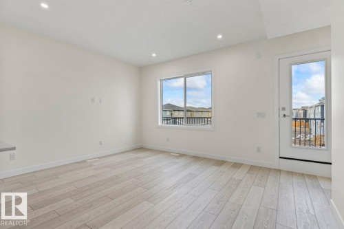 The living space features light-toned flooring, white walls, and recessed lighting - 42 Corner Glen Manor Ne, Calgary, AB - Indoor Photo Showing Other Room