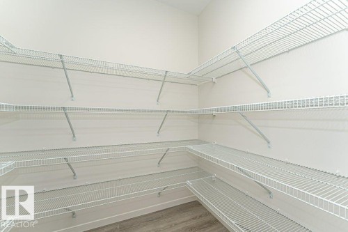 The property features a spacious closet with white wire shelving, providing extensive storage options - 6298 180 Avenue, Edmonton, AB - Indoor With Storage