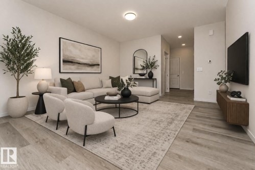 Living area featuring light wood-style flooring, a recessed lighting, and a neutral color palette - 6298 180 Avenue, Edmonton, AB - Indoor Photo Showing Living Room