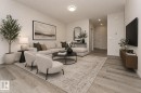 Living area featuring light wood-style flooring, a recessed lighting, and a neutral color palette - 6298 180 Avenue, Edmonton, AB  - Indoor Photo Showing Living Room 