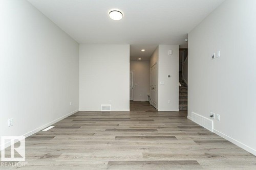 Living area featuring light-toned flooring, light-colored walls, and overhead lighting - 6298 180 Avenue, Edmonton, AB - Indoor Photo Showing Other Room