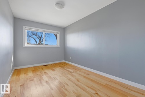 This room features hardwood floors and a window providing natural light - 10612 79 Street, Edmonton, AB - Indoor Photo Showing Other Room