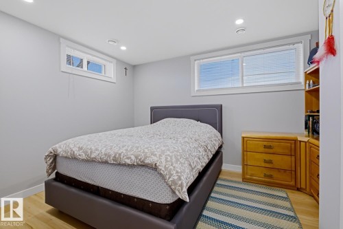 Room with light-colored walls, light wood flooring, and recessed ceiling lights - 10612 79 Street, Edmonton, AB - Indoor Photo Showing Bedroom