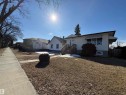 This property features a front yard with a lawn, a small shrub, and a concrete sidewalk - 10835/39/45/49 73 Avenue, Edmonton, AB 