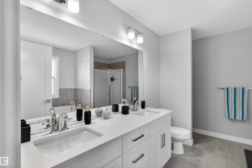 This bathroom features a double vanity with two sinks, ample counter space, and integrated storage - 42 Prescott Boulevard, Spruce Grove, AB - Indoor Photo Showing Bathroom