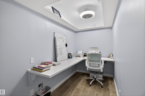 This room features light blue walls, wood-style flooring, and a recessed ceiling panel with a ceiling light fixture - 42 Prescott Boulevard, Spruce Grove, AB - Indoor Photo Showing Office
