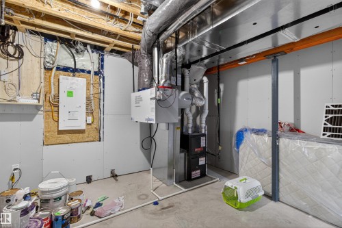 This space features exposed ceiling joists, various utility pipes, and electrical wiring - 42 Prescott Boulevard, Spruce Grove, AB - Indoor Photo Showing Basement