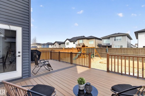 The property includes a spacious outdoor deck with wood railings, providing access to the yard - 42 Prescott Boulevard, Spruce Grove, AB - Outdoor With Deck Patio Veranda With Exterior