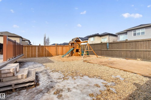 The property features a fenced yard with a combination of gravel and concrete surfaces, and a deck with railings - 42 Prescott Boulevard, Spruce Grove, AB - Outdoor