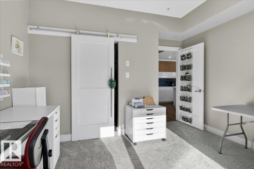 This room features light gray walls, a light gray carpet, and white trim - 214 528 Griesbach Parade Parade, Edmonton, AB - Indoor