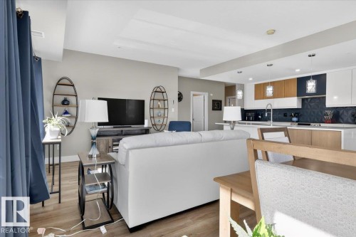Open concept living area with hardwood style flooring and recessed lighting - 214 528 Griesbach Parade Parade, Edmonton, AB - Indoor
