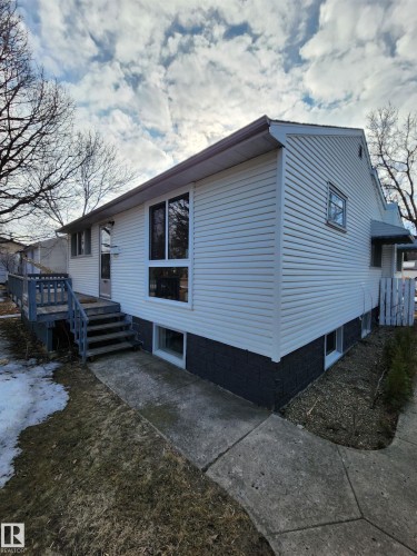 The property features white siding and a contrasting dark foundation - 10305 98 Avenue, Fort Saskatchewan, AB - Outdoor