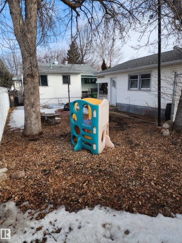 The property features a backyard area with exposed earth and some areas of snow cover - 10305 98 Avenue, Fort Saskatchewan, AB - Outdoor