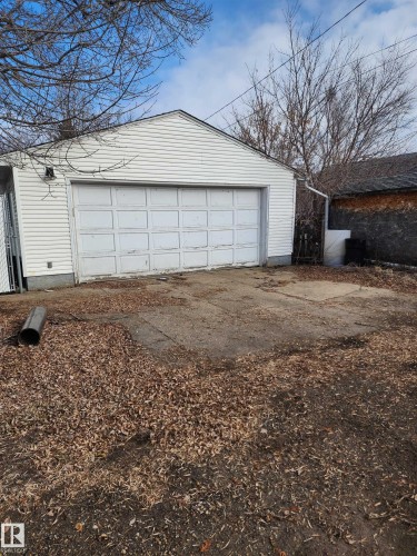 Detached garage with white siding and a white garage door - 10305 98 Avenue, Fort Saskatchewan, AB - Outdoor