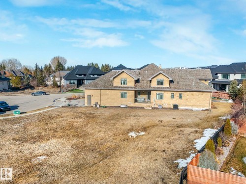The property features a large yard with a paved road and sidewalks - 2794 Wheaton Drive, Edmonton, AB 