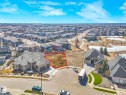 This property features an undeveloped lot, bordered by a paved driveway and residential streets - 2794 Wheaton Drive, Edmonton, AB 