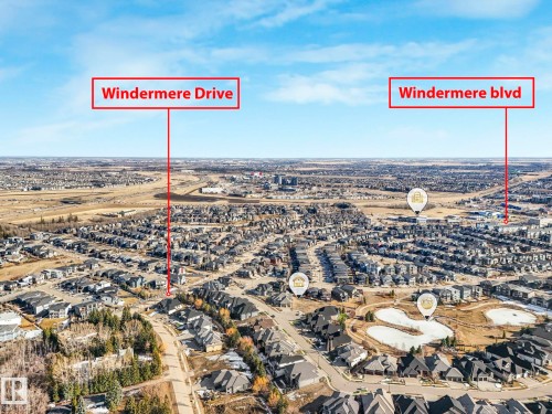 Aerial view of the surrounding neighborhood, featuring residential properties, roads, and a pond - 2794 Wheaton Drive, Edmonton, AB 