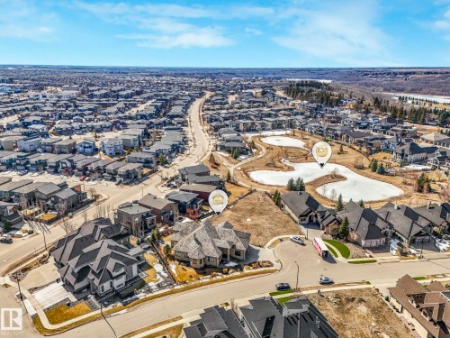 Aerial view of the community, showcasing an extensive residential area with numerous properties, winding roads, and several bodies of water - 2794 Wheaton Drive, Edmonton, AB 