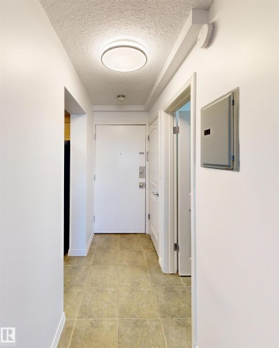 Entryway featuring tiled flooring, white walls, and a flush mount ceiling light - 303 8215 83 Avenue, Edmonton, AB - Indoor Photo Showing Other Room