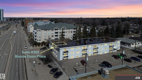 Aerial view of the property, featuring a multi-story building with balconies, a parking lot, and proximity to a major roadway - 303 8215 83 Avenue, Edmonton, AB - Outdoor With View